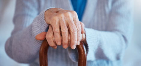 Elderly woman with walking cane